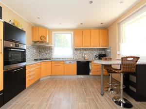 a kitchen with orange cabinets and a table in it at Apartment Beige by Interhome in Balatonszemes