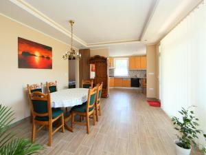 a dining room and kitchen with a table and chairs at Apartment Beige by Interhome in Balatonszemes