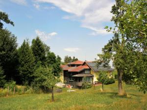 a house in the middle of a field with trees at Holiday Home große Winten by Interhome in Geinberg