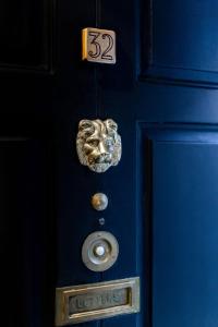 a blue door with a lion head on it at Clifden House by Nina in Dublin