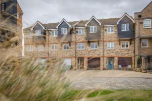 a large brick building with a large driveway at Harbour Views at Silver Strand in Pevensey