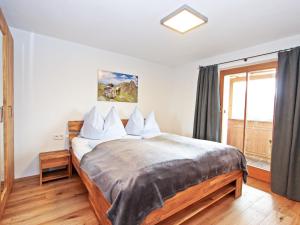 A bed or beds in a room at Apartment Renauer by Interhome