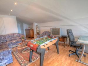 a living room with a chess board on a table at Apartment Emeraudes by Interhome in Anzère