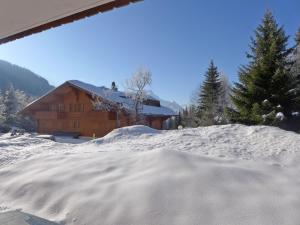 a pile of snow in front of a cabin at Apartment Aiguilles Dorées III-2 by Interhome in Villars-sur-Ollon