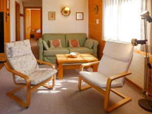 a living room with a couch and two chairs and a table at Apartment Aiguilles Dorées III-2 by Interhome in Villars-sur-Ollon