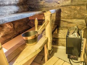 a bucket sitting on a wooden shelf in a kitchen at Holiday Home Kelovalta 7b by Interhome in Ruka