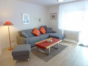 a living room with a couch and a table at Apartment Schwarzwaldblick-26 by Interhome in Obertal