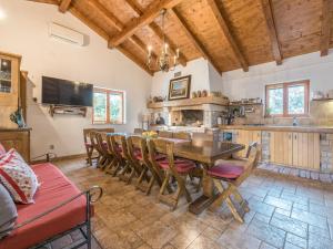 a kitchen and dining room with a wooden table and chairs at Holiday Home Malu Sun II by Interhome in Brodarica