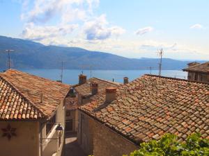 a group of roofs with a view of a lake at Apartment Formaga-3 by Interhome in Gargnano