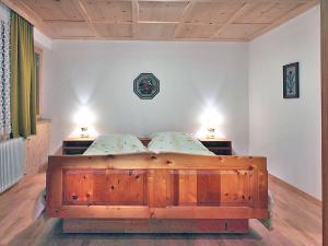 a large wooden bed in a bedroom with two lamps at Apartment Ainhauser-3 by Interhome in Rodund