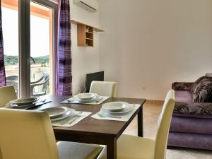 - une salle à manger avec une table et des chaises en bois dans l'établissement Apartment Milin-3 by Interhome, à Jezera