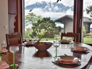 a table with glasses and a bowl of fruit on it at Villa Duck House by Interhome in Clarens