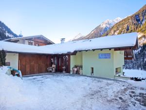 a guest house in the mountains in the snow at Apartment Neugasteig-3 by Interhome in Gasteig