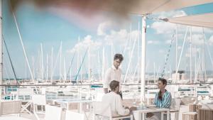 a group of people sitting at tables on a yacht at Marina di Scarlino Resort in Puntone di Scarlino
