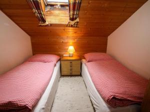a small room with two beds in a attic at Apartment Römer by Interhome in Bad Hofgastein