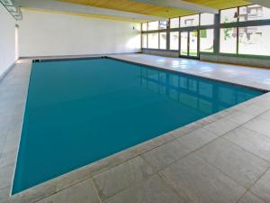 une grande piscine d'eau bleue dans l'établissement Apartment Les Genets-12 by Interhome, à Nendaz