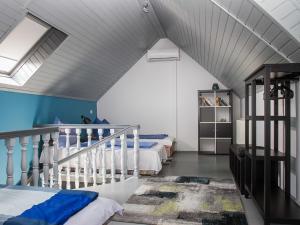 a attic room with two beds and a staircase at Apartment Cortaderia 2 by Interhome in Balatonkeresztúr