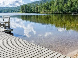 a bench sitting on a dock next to a lake at Holiday Home Hiisiranta b3 by Interhome in Kolinkylä +20 photos