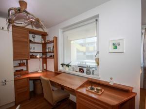 a home office with a wooden desk and a window at Apartment Tivoli by Interhome in Innsbruck
