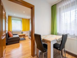 a dining room with a table and chairs at Apartment Kleinsee by Interhome in Srejach