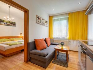 a living room with a couch and a bed at Apartment Kleinsee by Interhome in Srejach