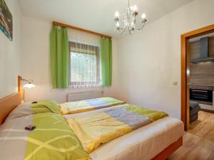 a bedroom with a bed and a chandelier at Apartment Kleinsee by Interhome in Srejach +19 photos