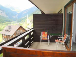 a balcony with two chairs and a table at Studio Top 46 A by Interhome in Heiligenblut