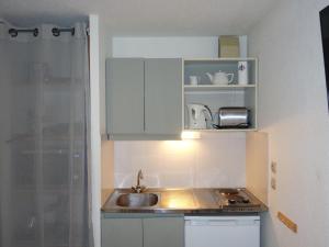 a kitchen with a sink and a counter top at Apartment La piste A by Interhome in Saint-Gervais-les-Bains
