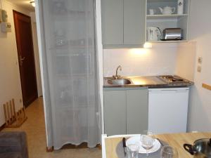 a kitchen with a sink and a shower curtain at Apartment La piste A by Interhome in Saint-Gervais-les-Bains