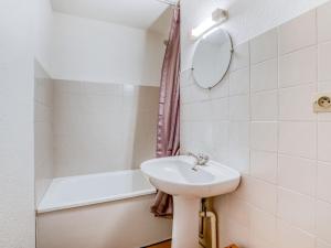 a bathroom with a sink and a bath tub at Apartment La Piste-3 by Interhome in Saint-Gervais-les-Bains