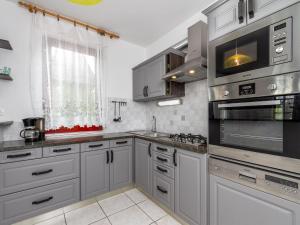 a kitchen with stainless steel appliances and a window at Holiday Home Yellow 2 by Interhome in Balatonmáriafürdő
