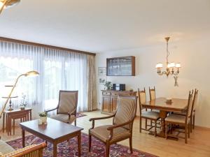 un soggiorno con tavolo da pranzo e sedie di Apartment Rustica Apt- M by Interhome a Wengen