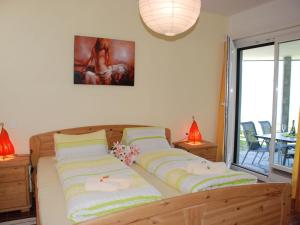 a bedroom with a bed with two pillows on it at Apartment Casablanca EG by Interhome in San Nazzaro
