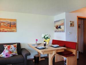 a living room with a table and a couch and a table and chairs at Apartment Casablanca EG by Interhome in San Nazzaro