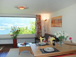 a living room with a table and a large window at Apartment Casablanca EG by Interhome in San Nazzaro