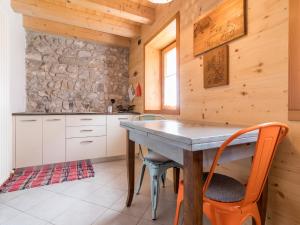 a kitchen with a table and chairs in a room at Apartment Albergo Diffuso - Cjasa Ustin-4 by Interhome in Barcis