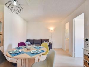 a dining room and living room with a table and chairs at Apartment Villa au plus près by Interhome in Mimizan-Plage