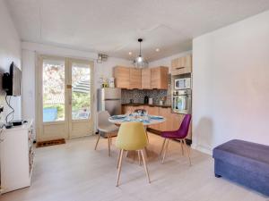 a kitchen and dining room with a table and chairs at Apartment Villa au plus près by Interhome in Mimizan-Plage