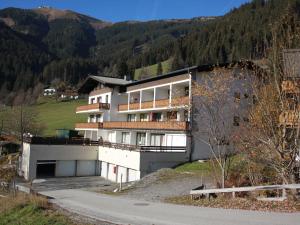 a building on a hill next to a road at Apartment Holiday-6 by Interhome in Zell am See