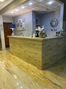 a lobby with a reception desk with a counter top at Hotel Puerta de Cazorla in Cazorla