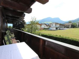 a balcony with a table and chairs and a field at Apartment Römerhof-5 by Interhome in Fügen