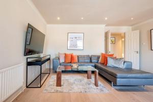 a living room with a couch and a table at Stunning 3-bedroom in the heart of London with parking-hosted by Sweetstay in London