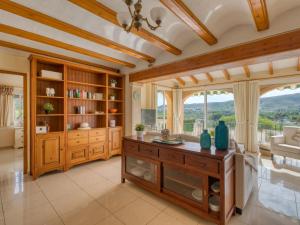 a living room with a table and a large window at Holiday Home Isabelle by Interhome in Jávea