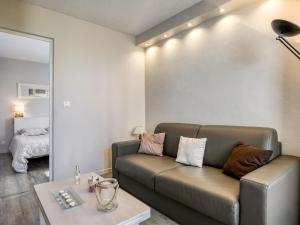 a living room with a couch and a table at Apartment Port Arcachon-1 by Interhome in Arcachon