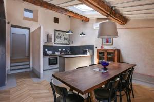 a kitchen with a wooden table and chairs at Belle Arti Penthouse-hosted by Sweetstay in Florence