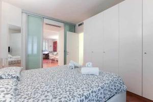 a bedroom with a bed with a teddy bear on it at Brera area Lovely Apt close to Piazza Duomo in Milan