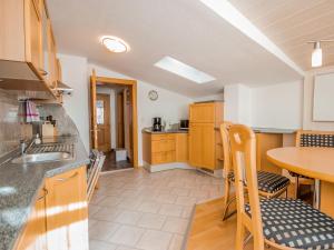 a kitchen with a sink and a table with chairs at Apartment Ferienwohnung Anna by Interhome in Umhausen