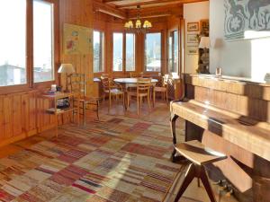 a dining room with a table and a bench at Apartment Marmousets 2 by Interhome in Chesières +25 photos