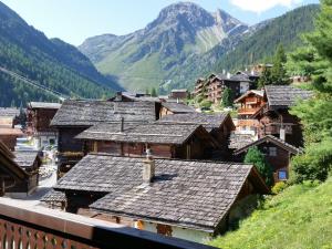 a village in the mountains with mountains in the background at Chalet Chalet A Coeur by Interhome in Grimentz