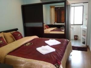 a bedroom with a bed with two towels on it at Baitong Homestay in Chiang Mai